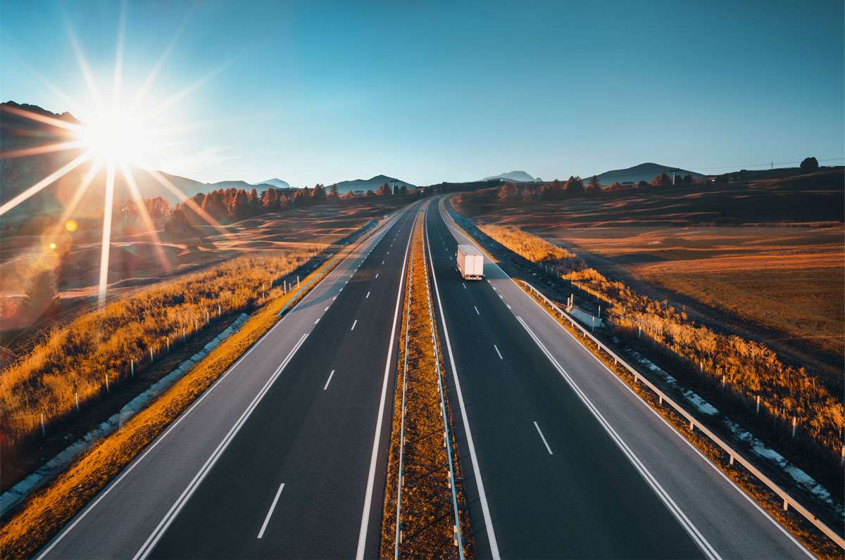 freight-forwarding-services-1-720 A lone truck drives by two highways in a gorgeous stretch.